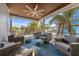 Inviting outdoor porch with comfortable seating and a ceiling fan at 108 Magnolia Ave, Anna Maria, FL 34216