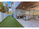Backyard featuring a putting green, outdoor kitchen, and ping pong table, perfect for entertaining at 108 Magnolia Ave, Anna Maria, FL 34216