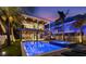 Outdoor living with a pool, hot tub, covered seating, and tropical landscaping at 108 Magnolia Ave, Anna Maria, FL 34216