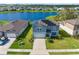 Aerial view of beautiful home with solar panels overlooking a peaceful pond at 11531 Moonsail Dr, Parrish, FL 34219