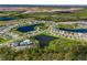 An aerial view showcases the community's serene lakes, swimming pool, and recreational amenities at 11531 Moonsail Dr, Parrish, FL 34219