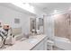 Bright bathroom features tiled shower/tub, neutral color palette, and modern vanity with sink at 11531 Moonsail Dr, Parrish, FL 34219