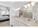 Bathroom featuring double sinks, a shower, and views to the bedroom at 11531 Moonsail Dr, Parrish, FL 34219