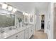 Bathroom featuring double sinks, a shower, and framed mirrors at 11531 Moonsail Dr, Parrish, FL 34219