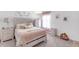 Cozy bedroom featuring unique headboard design, carpet flooring, and matching bedside table at 11531 Moonsail Dr, Parrish, FL 34219