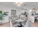 Bright dining area features a modern chandelier and a round table with seating for four at 11531 Moonsail Dr, Parrish, FL 34219