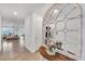 Inviting entryway featuring tile floors, an ornate mirror, and a glimpse into the open-concept living spaces at 11531 Moonsail Dr, Parrish, FL 34219