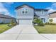 Charming two-story home featuring a manicured lawn and an attached two-car garage at 11531 Moonsail Dr, Parrish, FL 34219