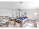 Large game room features a pool table, a sectional sofa, and a ceiling fan for added comfort at 11531 Moonsail Dr, Parrish, FL 34219