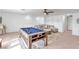 Spacious game room features a pool table, comfortable seating, and ample space for entertainment at 11531 Moonsail Dr, Parrish, FL 34219