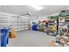 Spacious two-car garage featuring ample storage racks and overhead lighting at 11531 Moonsail Dr, Parrish, FL 34219