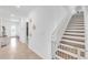 Bright hallway with tiled floors leading to the main living areas and staircase to the second level at 11531 Moonsail Dr, Parrish, FL 34219