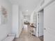 Hallway leading into the living room with a bench and wall art at 11531 Moonsail Dr, Parrish, FL 34219