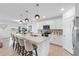 Modern kitchen featuring an island with barstool seating, stainless steel appliances, and ample counter space at 11531 Moonsail Dr, Parrish, FL 34219