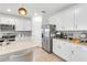 A bright kitchen features white cabinets, stainless appliances, and a cozy coffee bar at 11531 Moonsail Dr, Parrish, FL 34219
