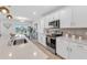 Beautiful kitchen with modern appliances, white countertops, and a view of the lake at 11531 Moonsail Dr, Parrish, FL 34219