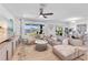 Open-concept living room with plush sectional, large windows, and water views at 11531 Moonsail Dr, Parrish, FL 34219