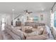 Cozy living room with stylish furnishings, a ceiling fan, and seamless connection to other living spaces at 11531 Moonsail Dr, Parrish, FL 34219