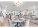 Bright and open-concept living space featuring modern decor, a dining area, and seamless flow to the kitchen at 11531 Moonsail Dr, Parrish, FL 34219