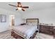 Bedroom featuring ceiling fan, art, and a patterned rug at 11531 Moonsail Dr, Parrish, FL 34219