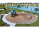 Community playground situated near a lake offers a safe and fun play area for families at 11531 Moonsail Dr, Parrish, FL 34219