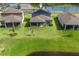 A well-maintained lawn complements the covered patio of this home next to a serene water view at 11531 Moonsail Dr, Parrish, FL 34219