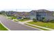 Street view of new two-story home with solar panels and well-manicured landscaping at 11531 Moonsail Dr, Parrish, FL 34219