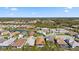 Expansive aerial view showcasing the community, lush landscape, and tranquil lake at 11981 Hunters Creek Rd, Venice, FL 34293