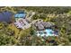 Aerial view showcasing the community clubhouse, pool and parking area at 11981 Hunters Creek Rd, Venice, FL 34293