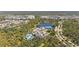 Aerial showcasing the clubhouse, tennis courts, pool, and the community's scenic pond at 11981 Hunters Creek Rd, Venice, FL 34293