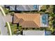 Aerial view of the property highlighting a backyard pool and a terracotta tile roof at 11981 Hunters Creek Rd, Venice, FL 34293