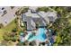 An aerial view of a community pool area with tropical landscaping and ample lounge chairs at 11981 Hunters Creek Rd, Venice, FL 34293
