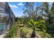 The conservation view offers privacy to the screened-in lanai and backyard, with mature trees and lush landscaping at 11981 Hunters Creek Rd, Venice, FL 34293