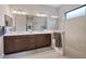 Elegant bathroom featuring double vanity, quartz counters, framed mirrors, and glass shower enclosure at 11981 Hunters Creek Rd, Venice, FL 34293