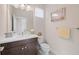 Bathroom featuring a vanity with a white sink, dark cabinetry, and neutral décor at 11981 Hunters Creek Rd, Venice, FL 34293