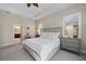 Comfortable primary bedroom with neutral decor, ensuite bathroom, and natural light at 11981 Hunters Creek Rd, Venice, FL 34293