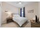 Cozy bedroom with a bed, neutral walls, ceiling fan and ample natural light at 11981 Hunters Creek Rd, Venice, FL 34293