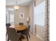 Cozy breakfast nook with a round table, four chairs, and lots of natural light at 11981 Hunters Creek Rd, Venice, FL 34293