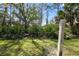 A conservation area sign and lush green space at 11981 Hunters Creek Rd, Venice, FL 34293