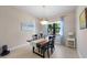 Elegant dining room with a modern chandelier, a window view and neutral finishes at 11981 Hunters Creek Rd, Venice, FL 34293