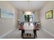 Formal dining room with a wood table, accent chairs, and modern lighting at 11981 Hunters Creek Rd, Venice, FL 34293