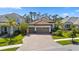 Stunning home featuring a paver driveway, three-car garage, and meticulously maintained landscaping at 11981 Hunters Creek Rd, Venice, FL 34293