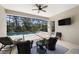 Screened lanai with ceiling fan, outdoor seating, and view of private swimming pool at 11981 Hunters Creek Rd, Venice, FL 34293