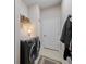 Convenient laundry room with modern washer and dryer units, shelving and a neutral color palette at 11981 Hunters Creek Rd, Venice, FL 34293