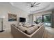 Spacious living room featuring a large sectional sofa and sliding glass doors to the pool at 11981 Hunters Creek Rd, Venice, FL 34293