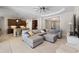 Open living room and kitchen with tile floors, ceiling fan, and view of entryway at 11981 Hunters Creek Rd, Venice, FL 34293