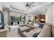 Open concept living room and kitchen featuring a large sectional sofa and modern appliances at 11981 Hunters Creek Rd, Venice, FL 34293