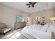 Bright main bedroom with neutral decor, tray ceiling, and ensuite bathroom access at 11981 Hunters Creek Rd, Venice, FL 34293