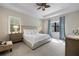 Tranquil main bedroom with tray ceiling, carpet, and natural light from large windows at 11981 Hunters Creek Rd, Venice, FL 34293