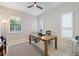 Bright office space with natural light, a ceiling fan, neutral walls, and tile flooring at 11981 Hunters Creek Rd, Venice, FL 34293